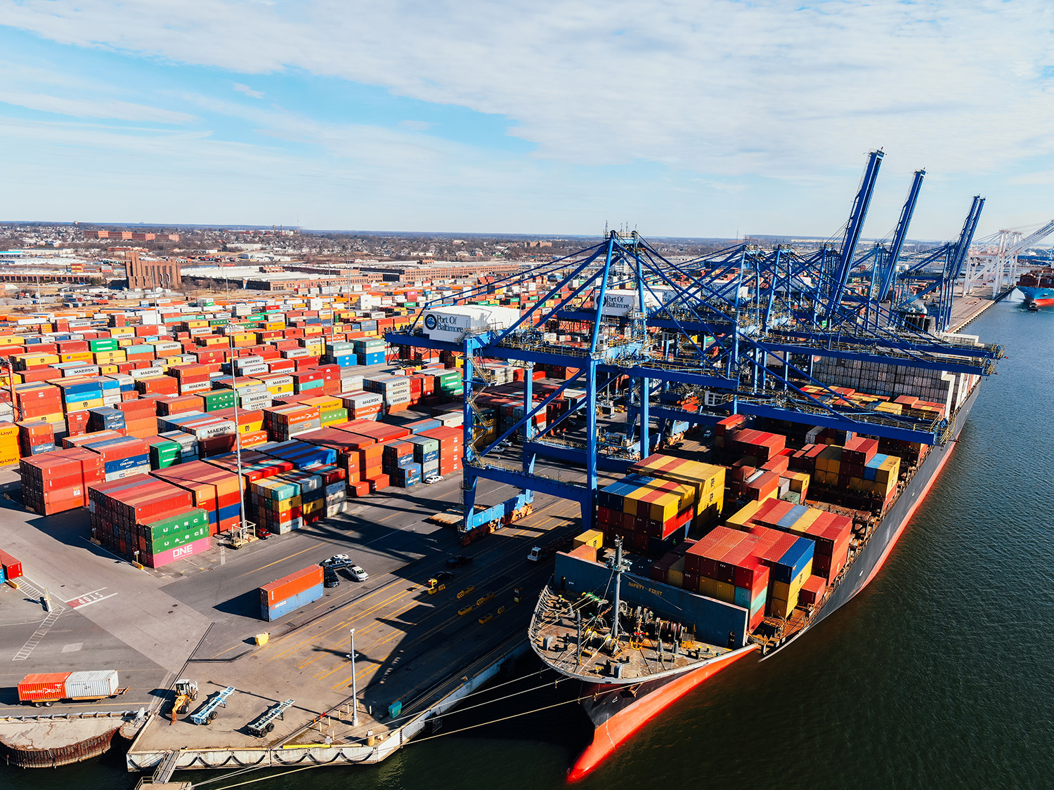 Container port with cranes loading shipping containers for international freight